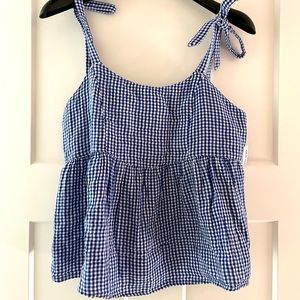 New with tags. Blue and white tie shoulder babydoll tank. Size S.